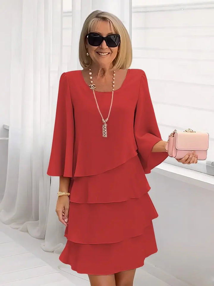 Flowing A-line women's dress featuring elegant ruffles and short sleeves, suitable for various occasions.
