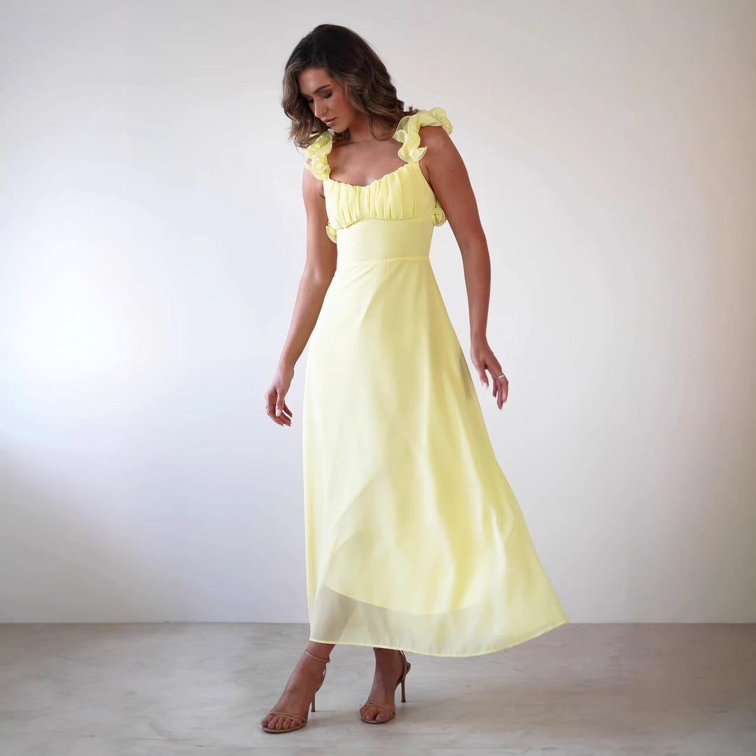 Beautiful women's wedding guest maxi dress with elegant ruffled shoulders and A-line silhouette. Sleeveless, formal.