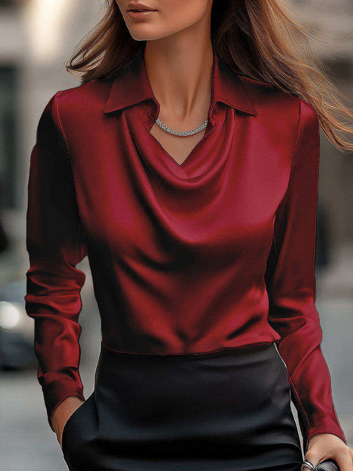 Flowing draped neck satin blouse for women. A refined long-sleeve top offering elegant style and comfort.