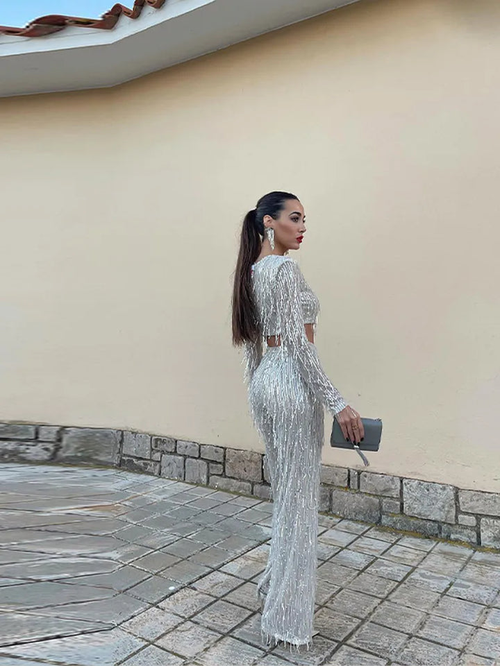 Festive sequin top and classic high-waist trousers for women. Elegant two-piece set for special occasions.