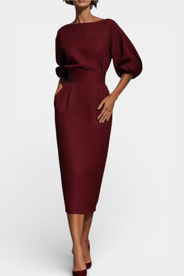 Women's formal boat neck sheath dress featuring dramatic lantern sleeves & a chic tapered hem for workwear.