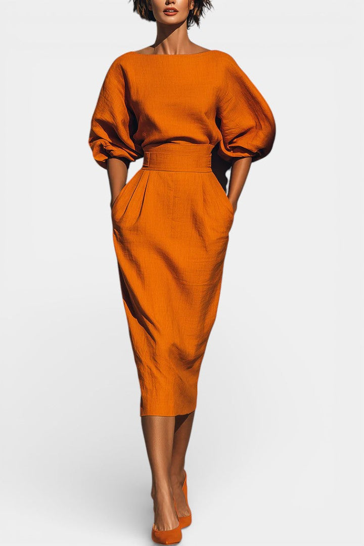 Sophisticated women's cocktail dress with elegant lantern sleeves and a flattering tapered sheath silhouette.