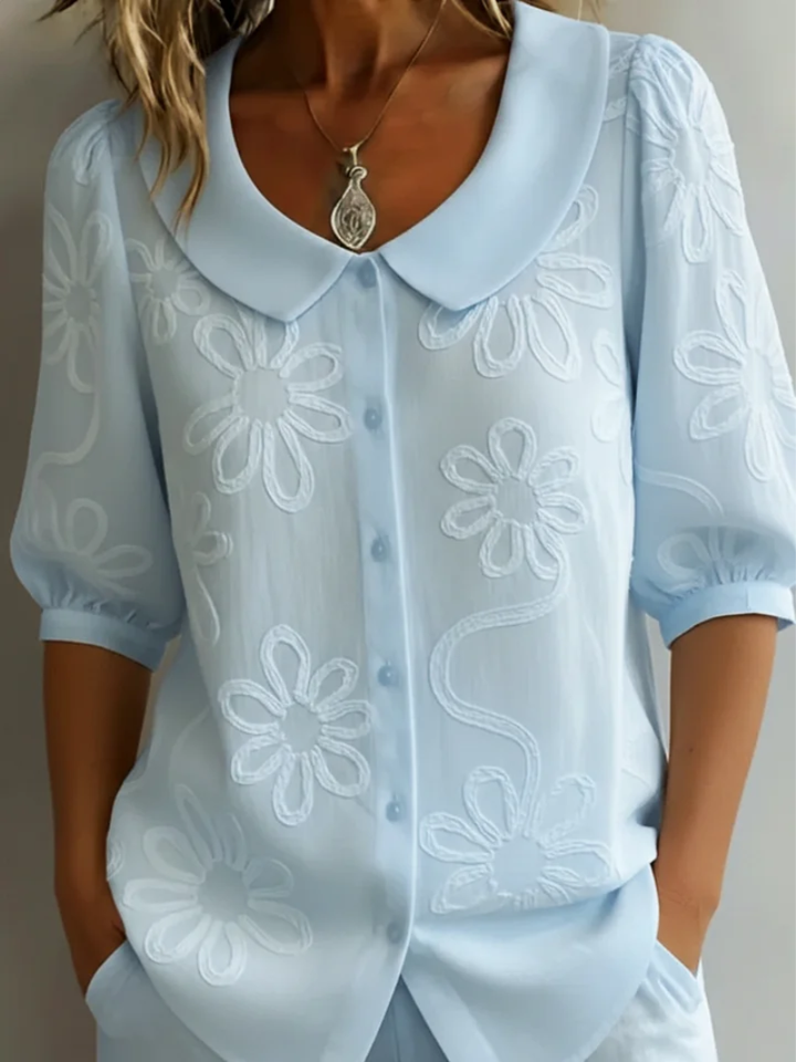 Chic ladies' short sleeve top, embroidered with flowers, offering a comfortable and stylish everyday look.