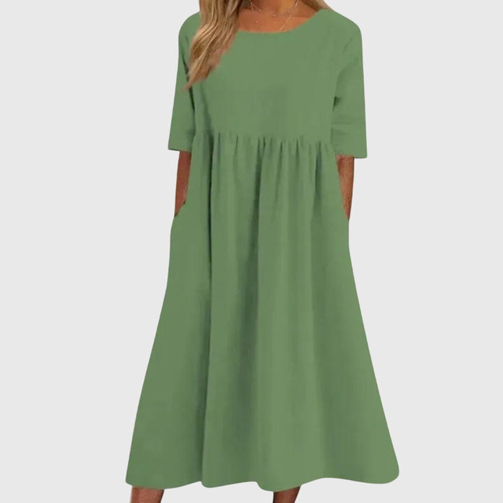 Chic women's short-sleeve dress. Elegant midi length, offering a flattering fit for sophisticated summer fashion.