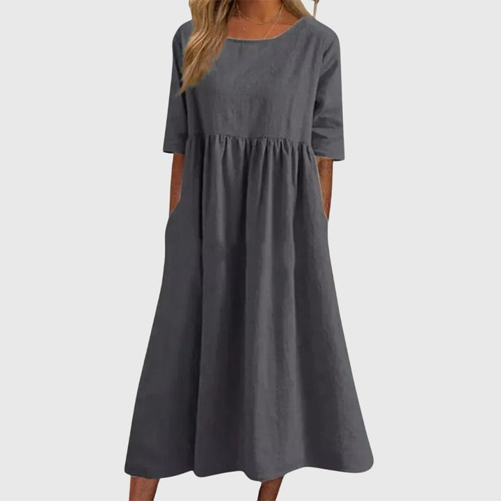 Women's elegant short-sleeve midi dress. Chic, versatile design with a flattering fit for effortless summer style.