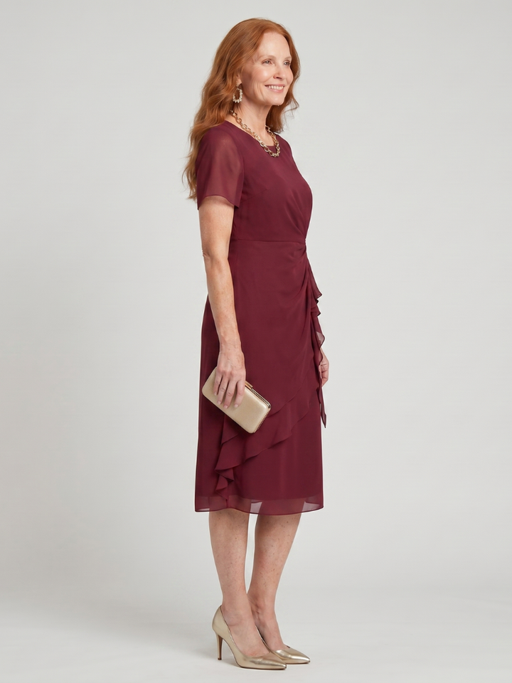 Chic women's short sleeve midi dress featuring a stylish layered hem, round neck, and twist waist detail.