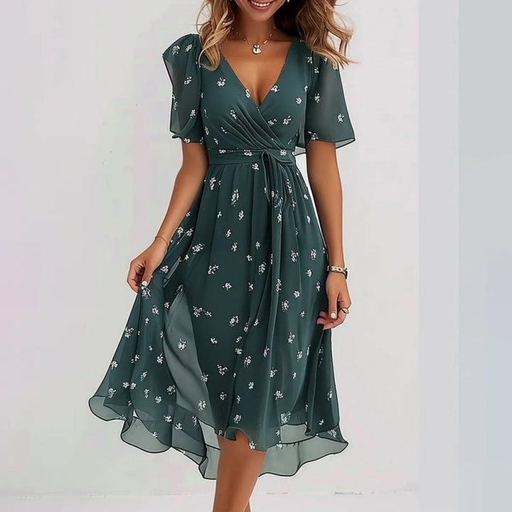 Women's elegant floral print puff sleeve midi dress with V-neck & asymmetrical hem, ideal for summer wear.