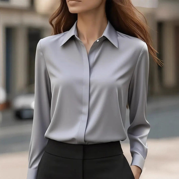 Sophisticated button-up silk blouse for women, ideal for workwear or evening wear.