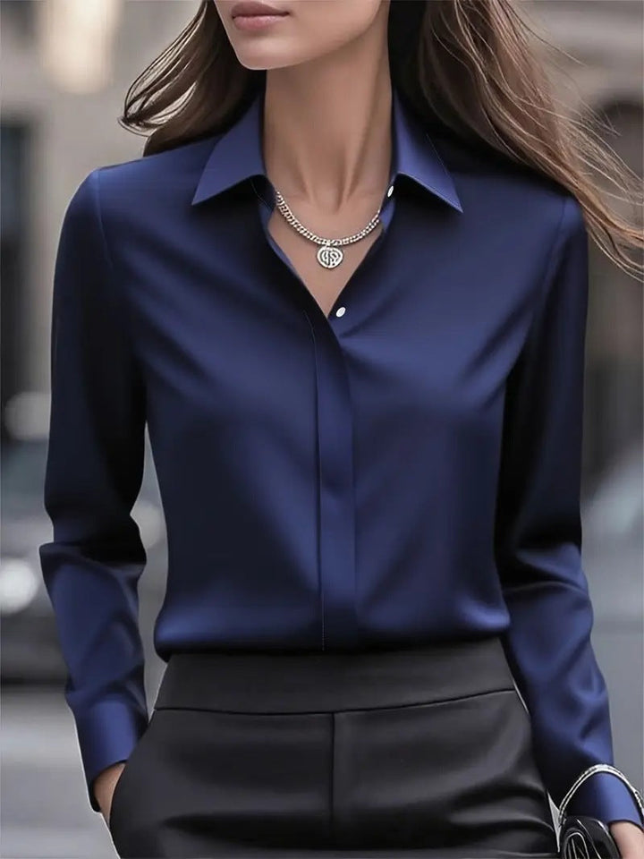 A close-up of the luxurious fabric of this elegant women's silk blouse.