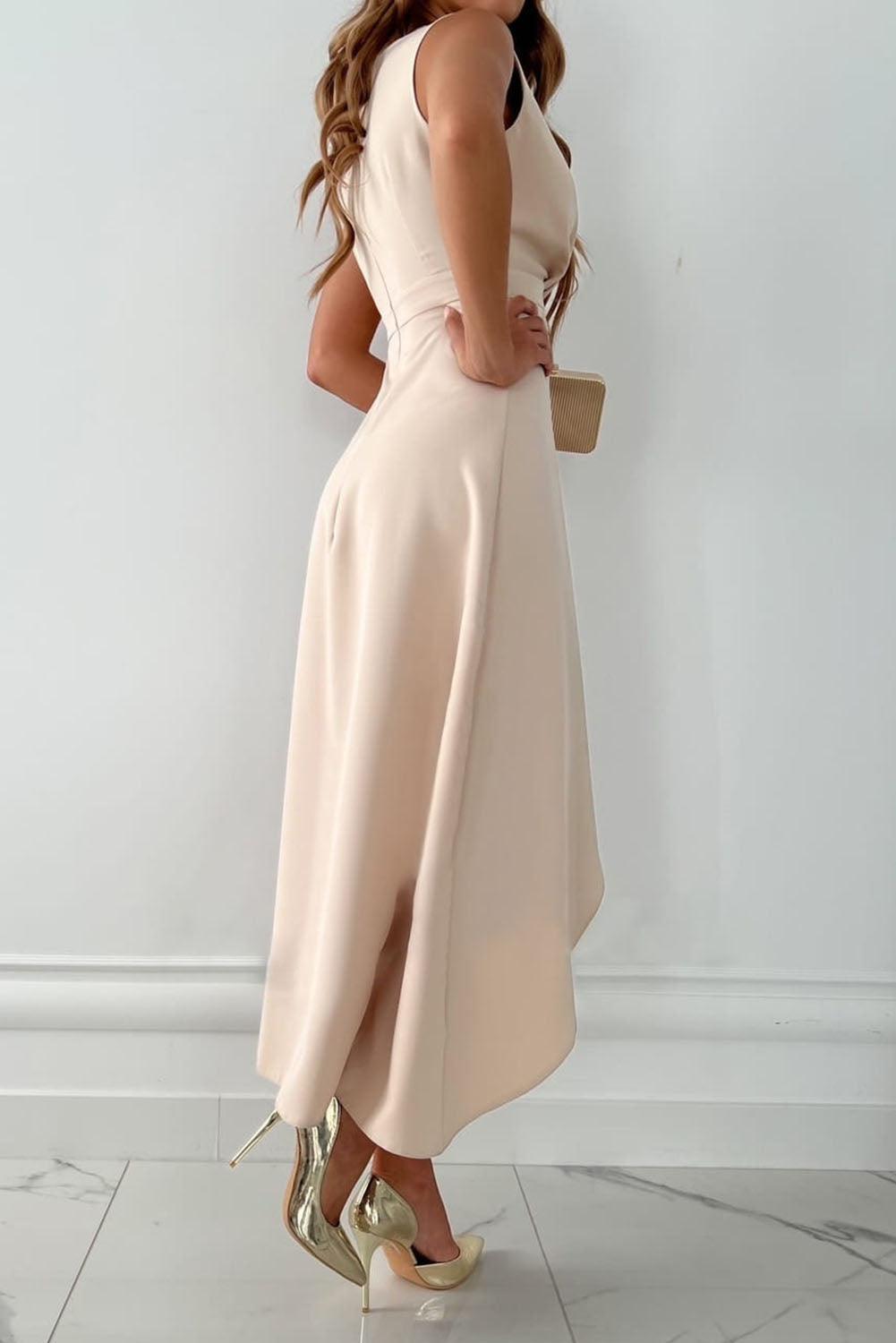 Beige sleeveless asymmetric midi dress for women. Elegant wedding guest attire, ideal for formal parties.