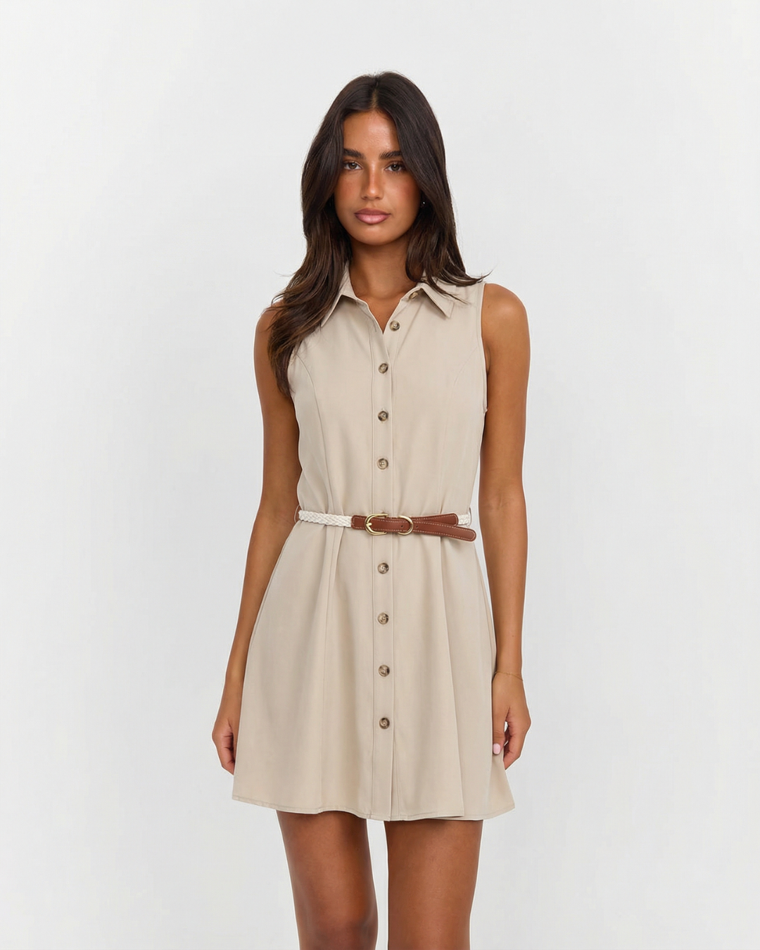 Elegant women's sleeveless beige mini shirt dress with button front. Perfect for summer office wear or stylish casual look.