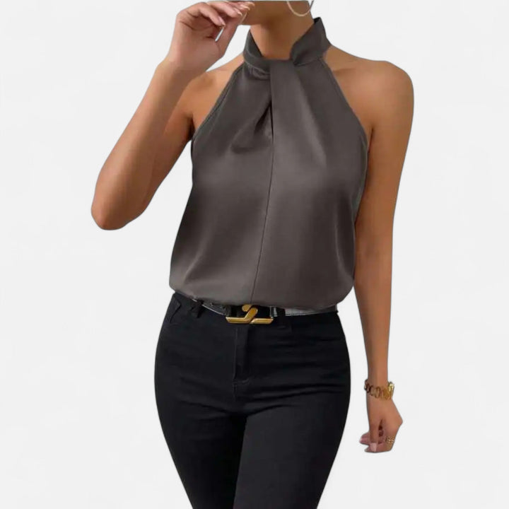 Women's elegant sleeveless twisted neck blouse, a chic and sophisticated top for various fashion styles.