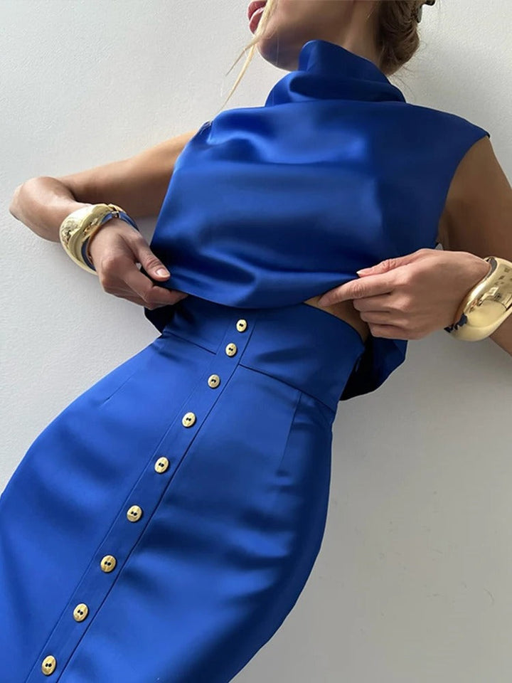 Women's sleeveless button-up cropped top & matching maxi skirt set, stylish and coordinated for summer.