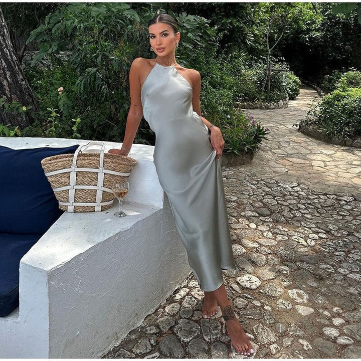 Chic sleeveless maxi dress, ideal for wedding guests & special occasions. Features a stylish open back design.