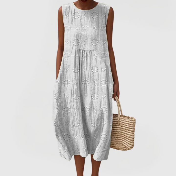Comfortable women's elegant sleeveless dress featuring convenient pockets, perfect for warm weather or vacation.