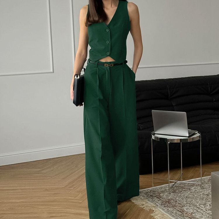 Full-length view of women's elegant tailored sleeveless waistcoat and wide-leg pant set for professional women.