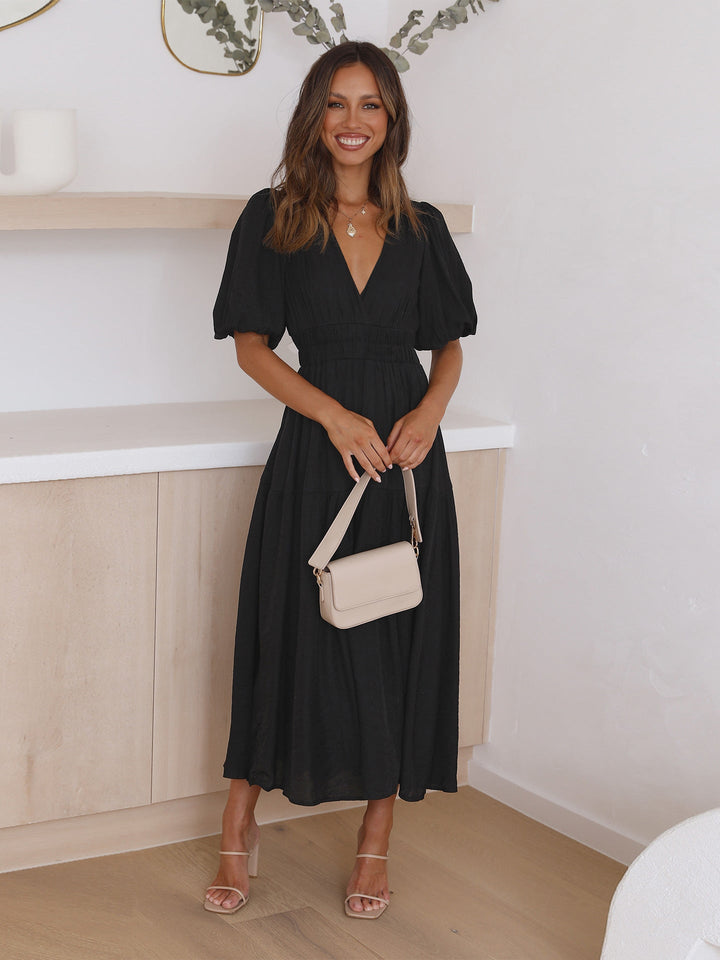 Chic pink smocked V-neck cocktail dress. Elegant midi length, perfect for special events.