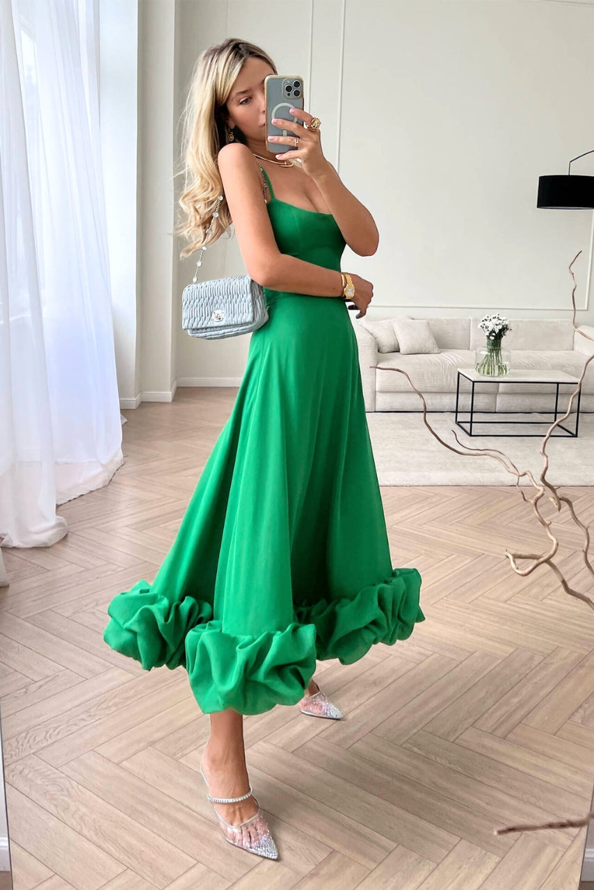 Women's summer party dress: spaghetti strap, high-waist, and a beautiful ruffled midi hem for chic occasion wear.