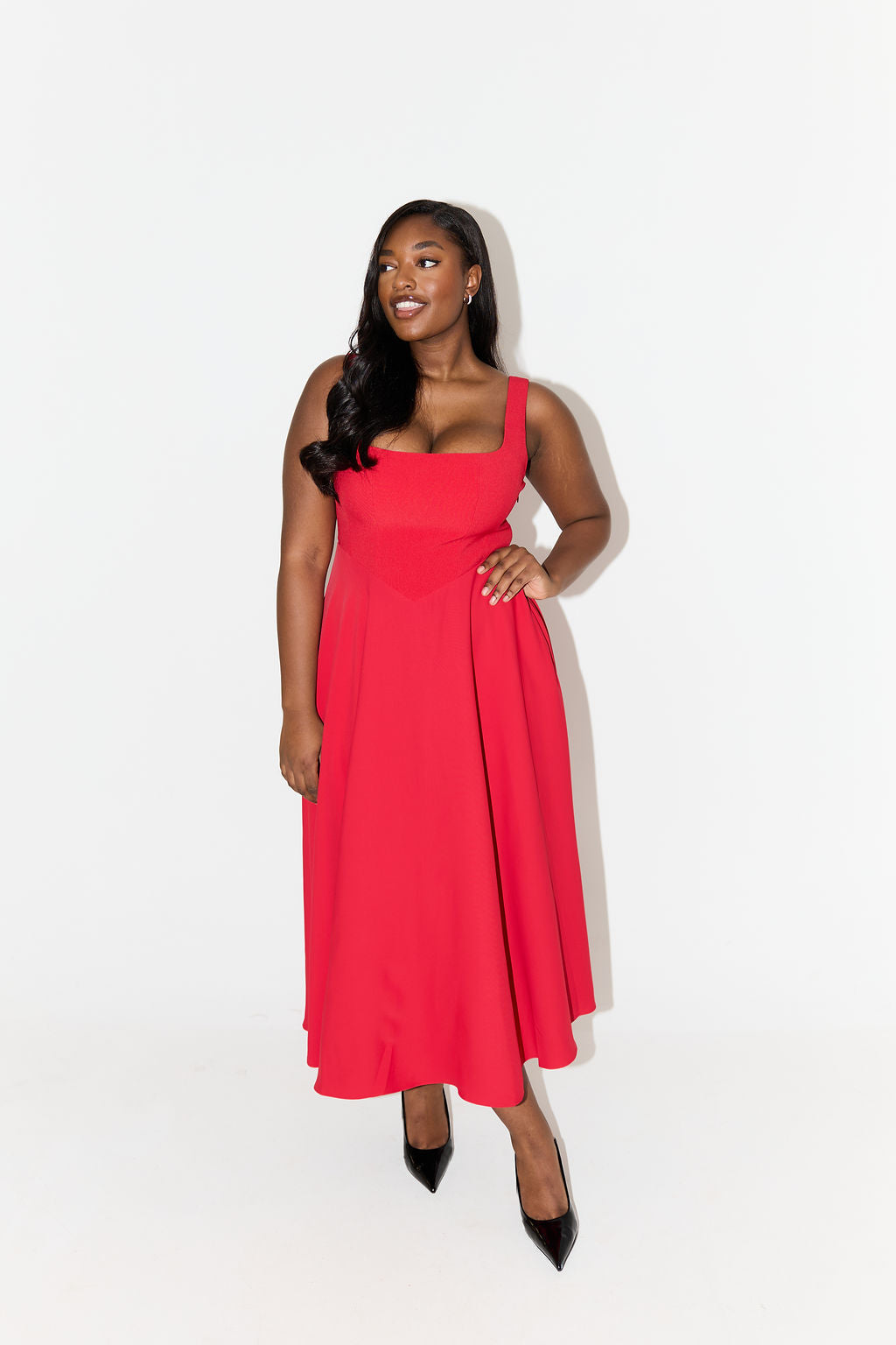 Women's elegant sleeveless midi dress with a flattering square neckline, A-line style.