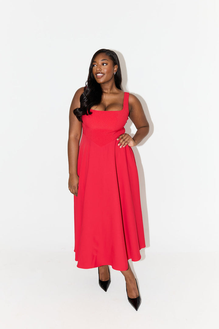 Women's elegant sleeveless midi dress with a flattering square neckline, A-line style.
