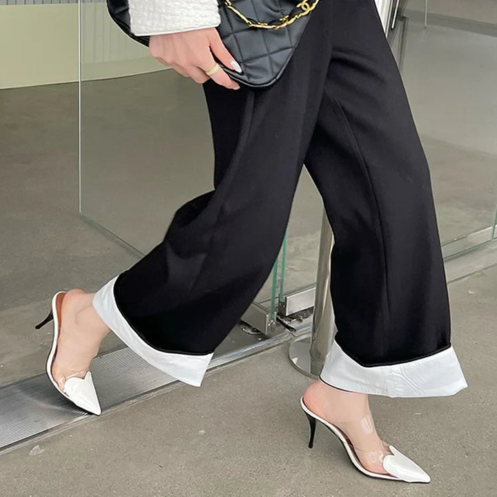 Stylish women's stiletto mules with a distinctive pointed heart toe, ideal for sophisticated evening events.