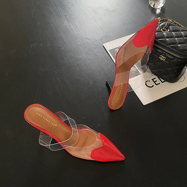 Women's stiletto mules featuring a sleek pointed toe with heart detail, perfect elegant slip-on party heels.