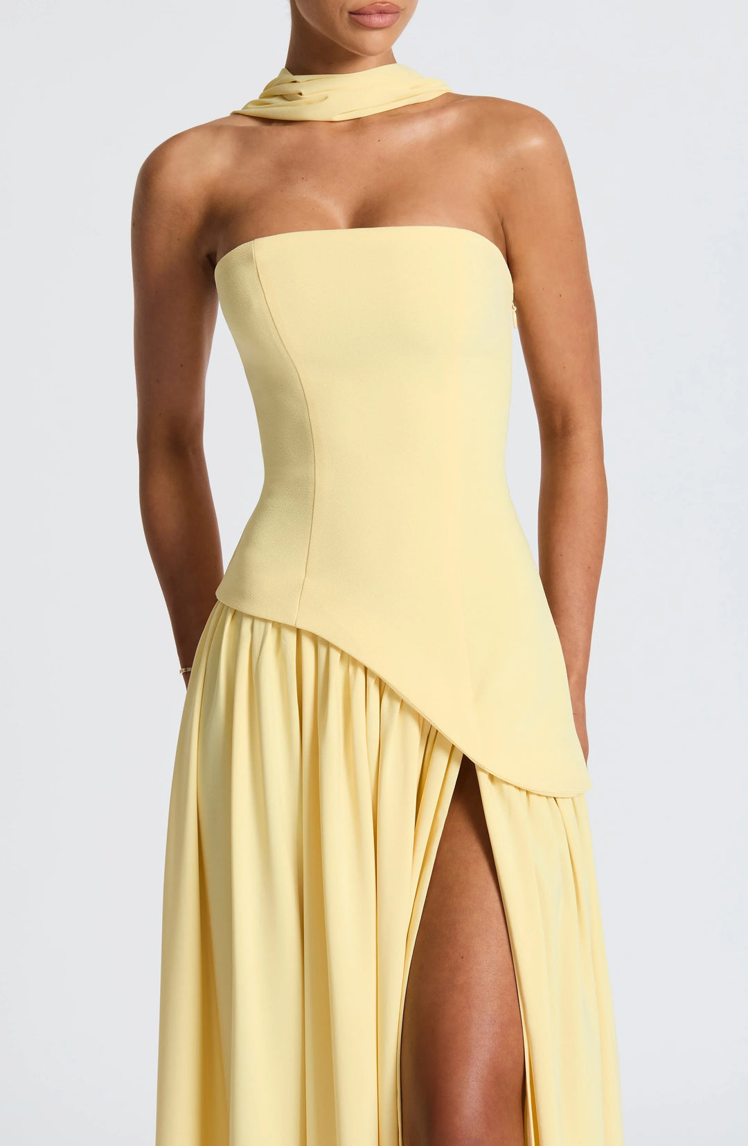 Chic women's strapless formal gown, corseted bodice, and a long skirt with an elegant side split.