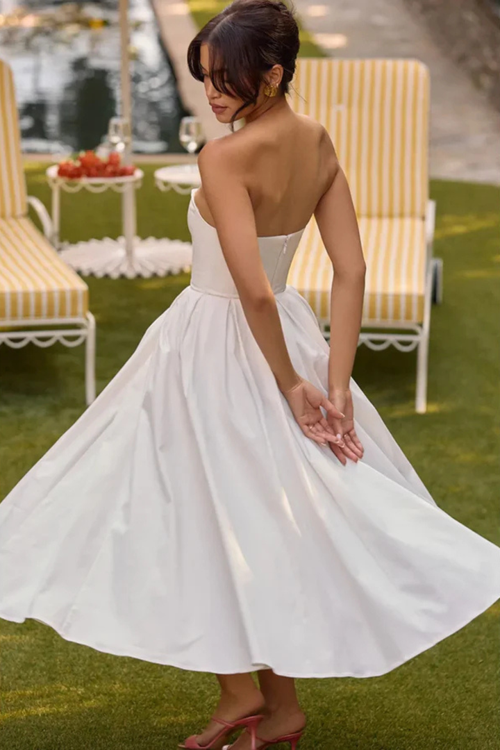 Stunning blue strapless corset midi dress, featuring an elegant flared A-line skirt for any special occasion.