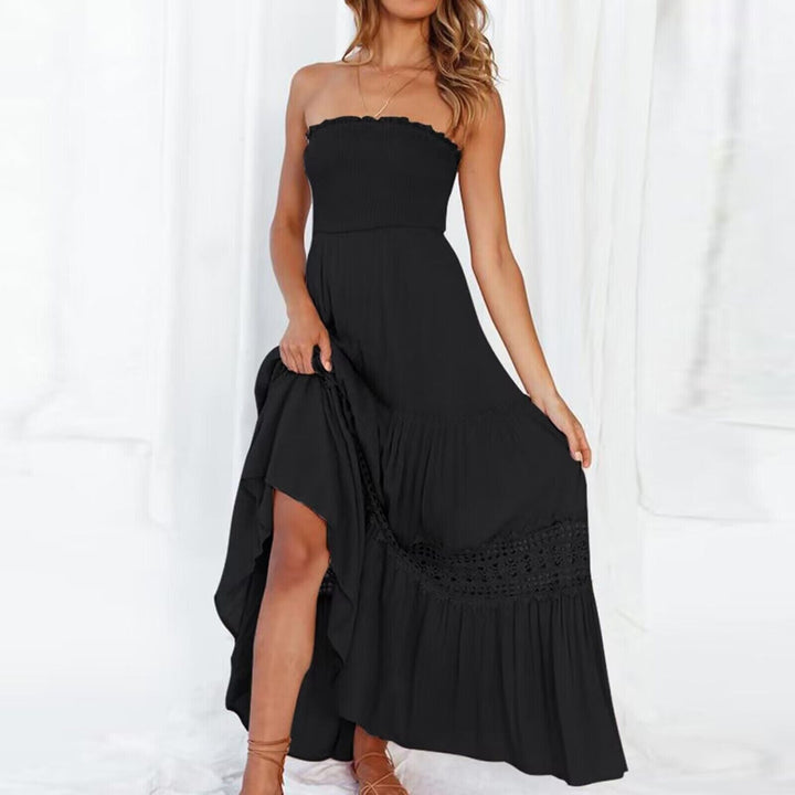 Fashionable women's strapless event wear maxi dress with a sophisticated high-low hem and tiered skirt.