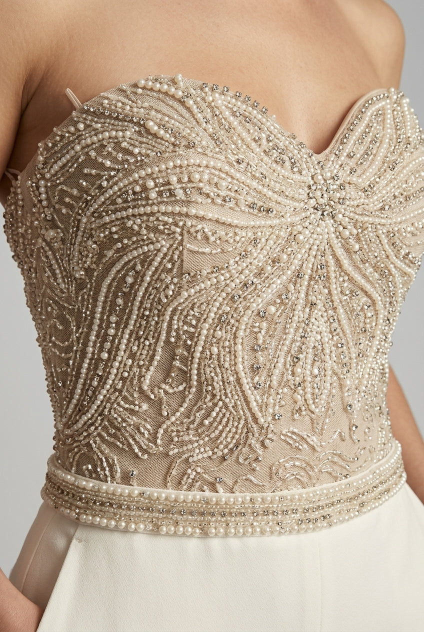 Chic women's strapless jumpsuit featuring a sweetheart neckline & straight leg, ideal for parties or wedding guests.