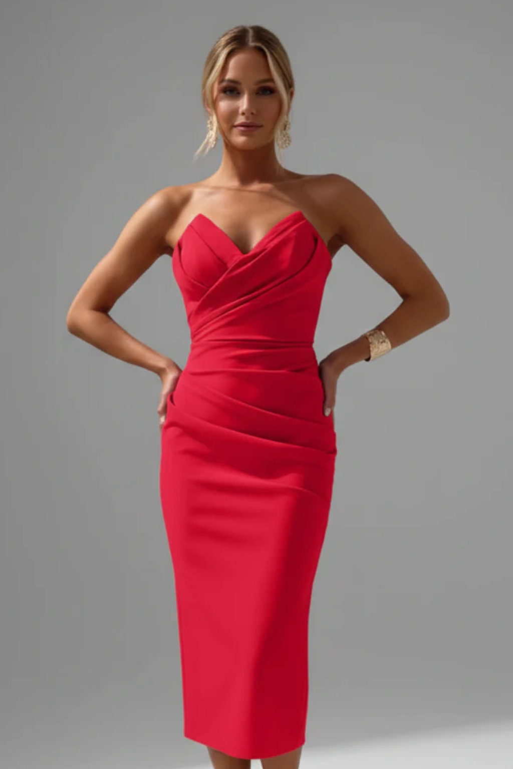 Women's fitted strapless midi dress featuring a sweetheart neckline & elegant side ruching. Cocktail ready.