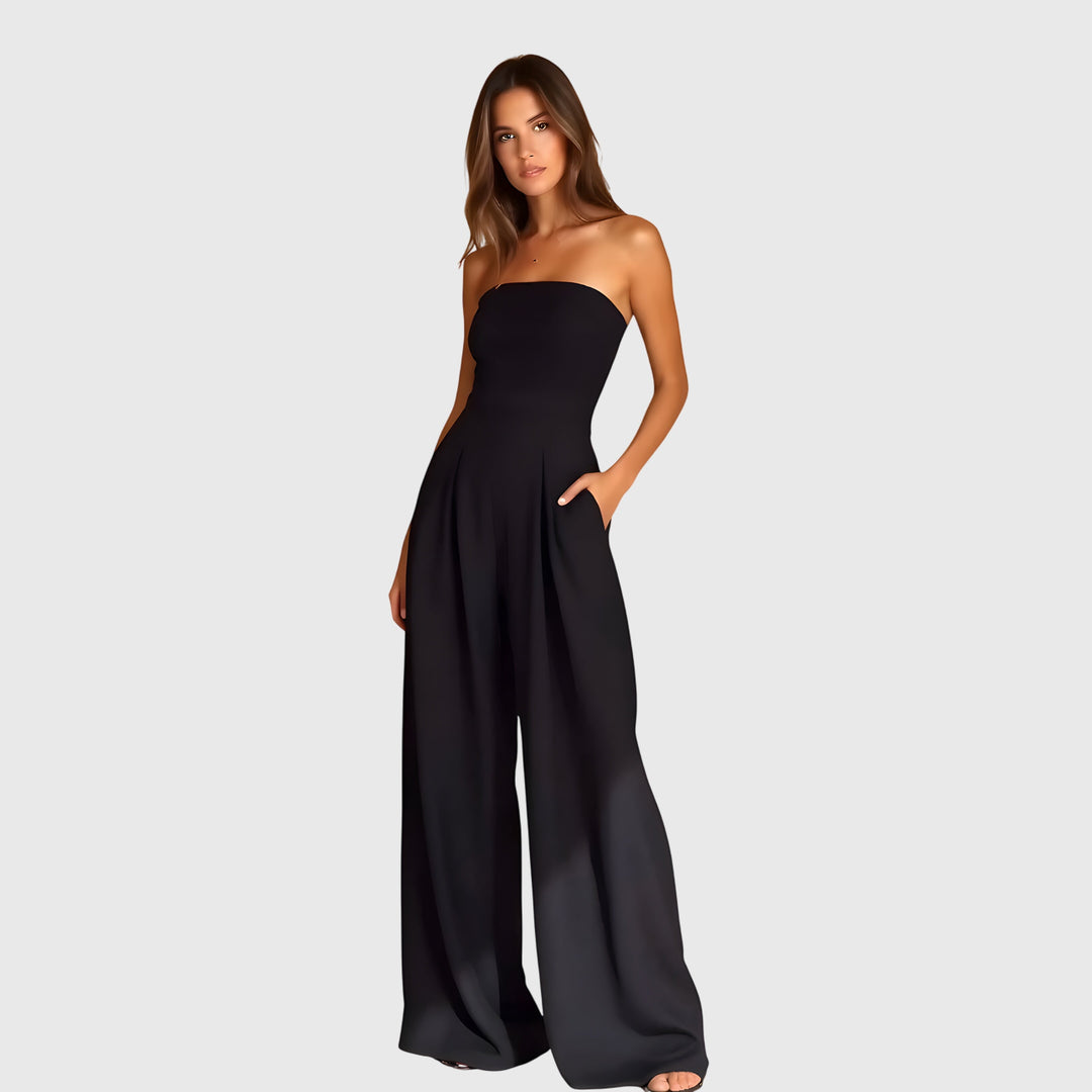 Sophisticated women's strapless wide-leg jumpsuit, featuring a stylish pleated waist for formal occasions.