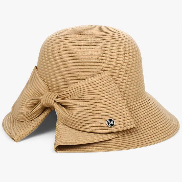 Elegant women's straw sun hat with an asymmetrical bow, perfect for beach days & summer sun protection.