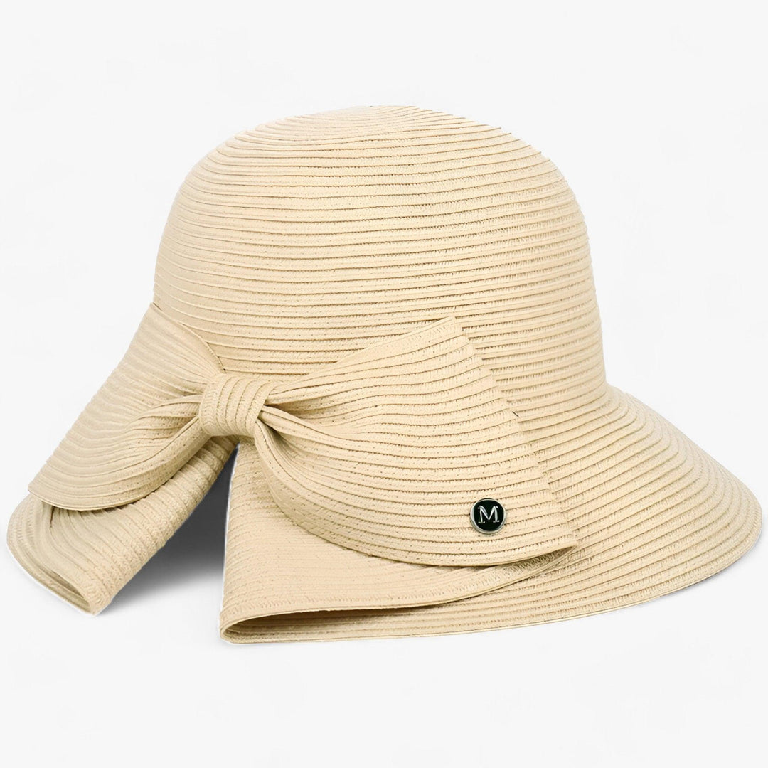 Resort-ready women's straw hat with an asymmetrical bow, providing stylish sun protection for any outdoor event.