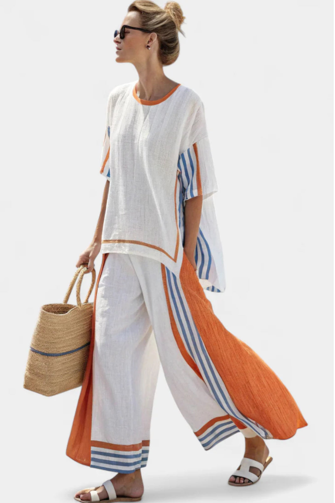 Elegant women's striped two-piece set featuring a stylish top & coordinating trousers, perfect for fashion-forward travel.