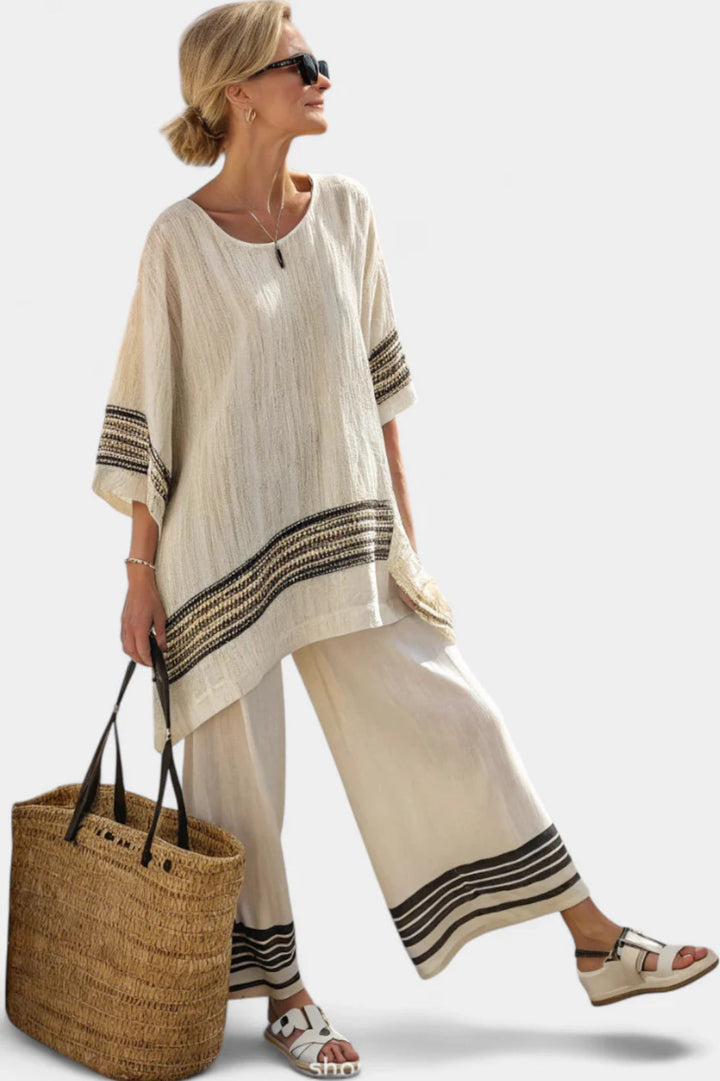 Chic women's striped two-piece set with a comfortable top & flowy trousers, great for elegant casual or travel outfits.