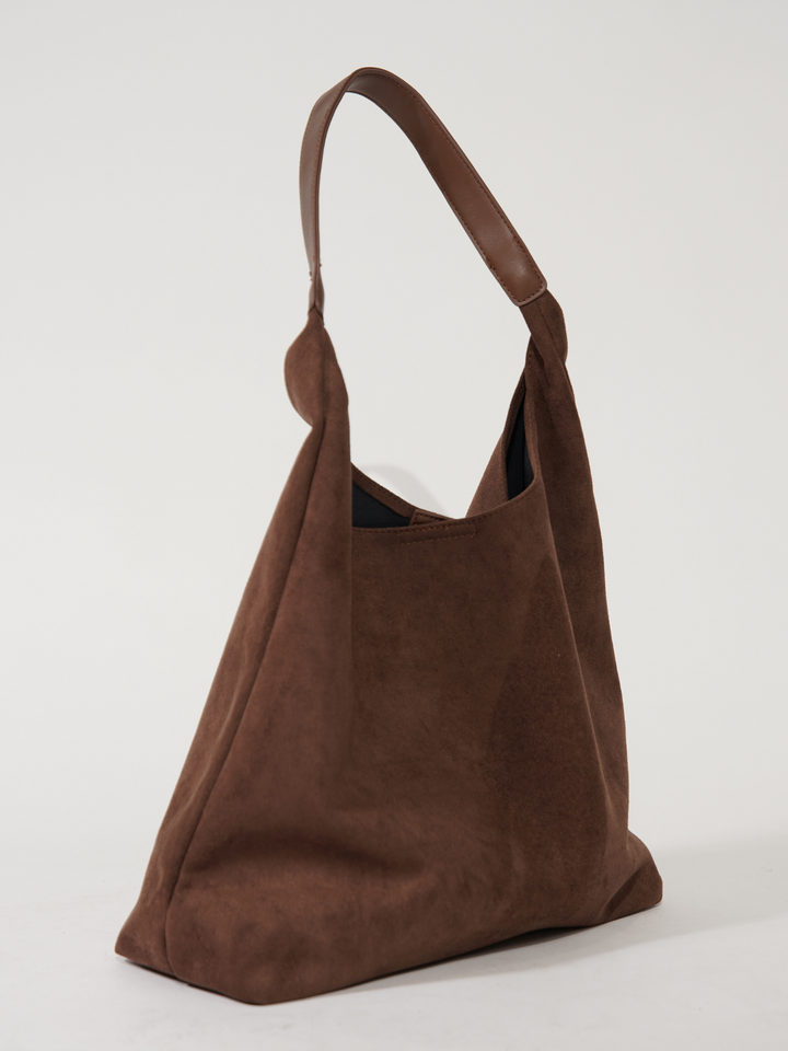 Brown elegant women's suede tote bag. Versatile everyday shoulder bag, perfect for stylish daily essentials.