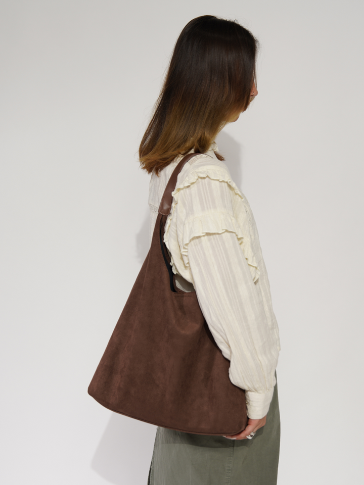 Black elegant women's suede tote bag. Versatile everyday shoulder bag, ideal for fashion-forward daily use.