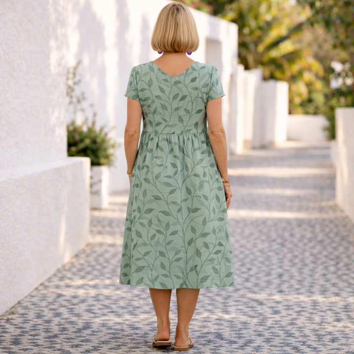Relaxed fit women's leaf print summer dress. Comfortable V-neck midi style for elegant day-to-night or vacation outfits.