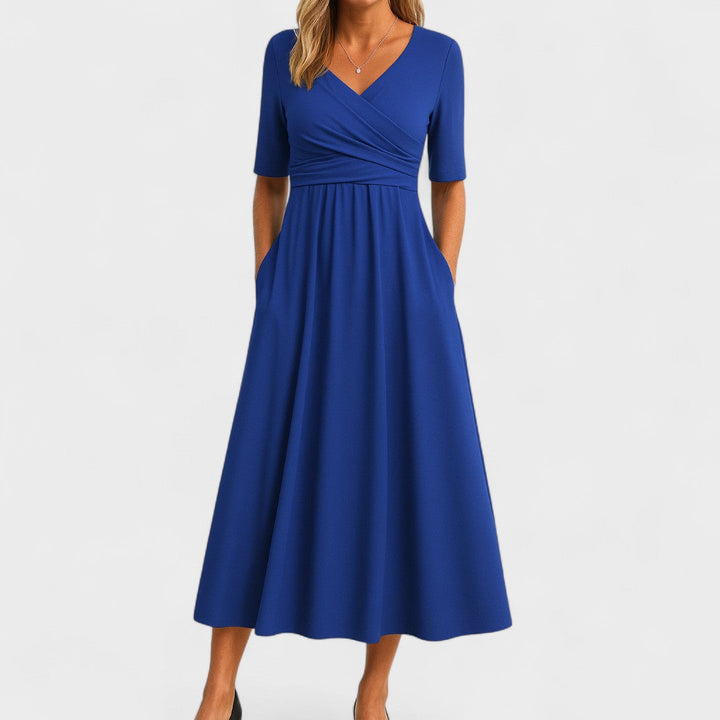 Comfortable women's midi dress featuring a stylish surplice V-neck and practical pockets.