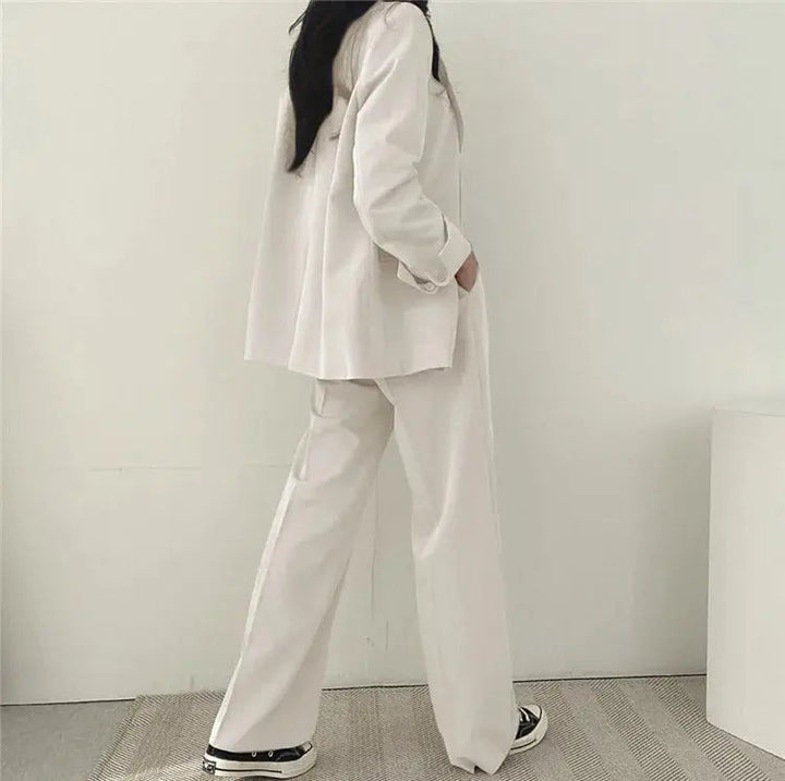 Women's fashion two-piece set: elegant tailored blazer and comfortable relaxed fit business trousers.