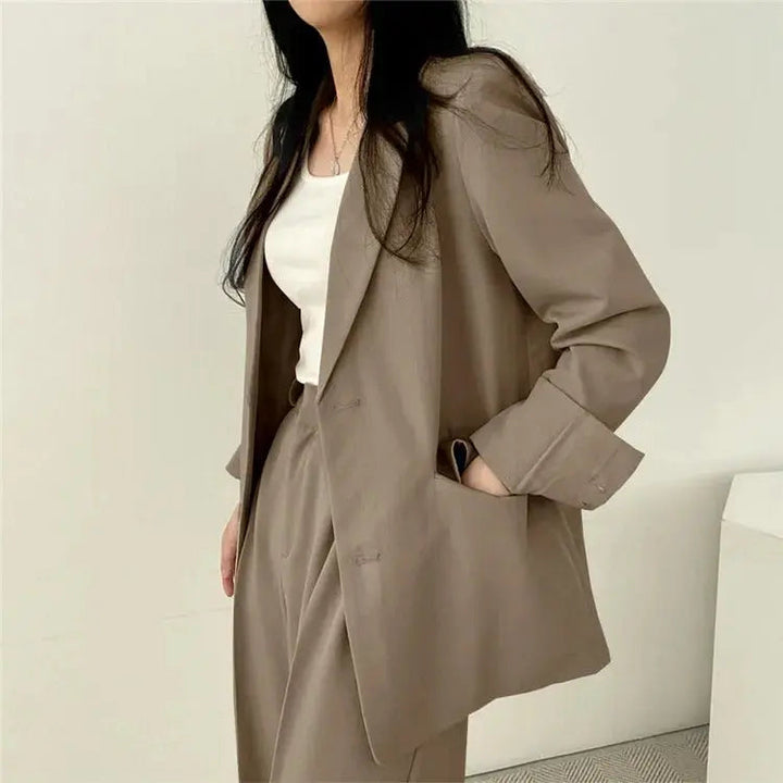 Women's elegant professional set with a sleek tailored blazer and relaxed, comfortable trousers.