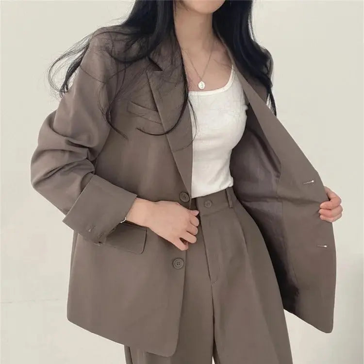 Professional women's blazer and relaxed fit trouser set, offering comfort and tailored sophistication.