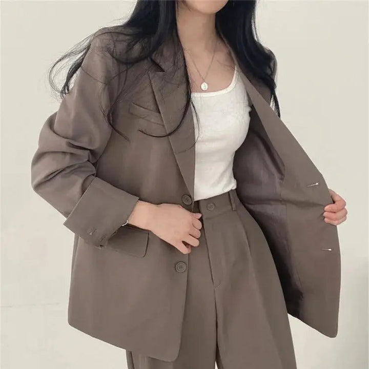 Professional women's blazer and relaxed fit trouser set, offering comfort and tailored sophistication.