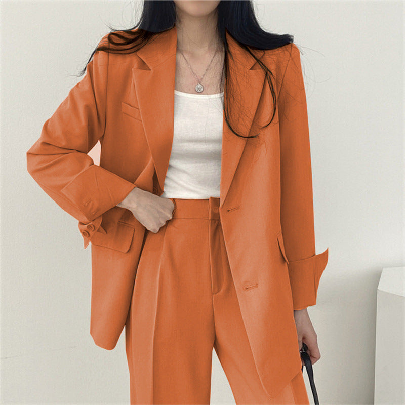 Women's fashion statement: tailored blazer and relaxed fit trousers, a sophisticated and versatile set.