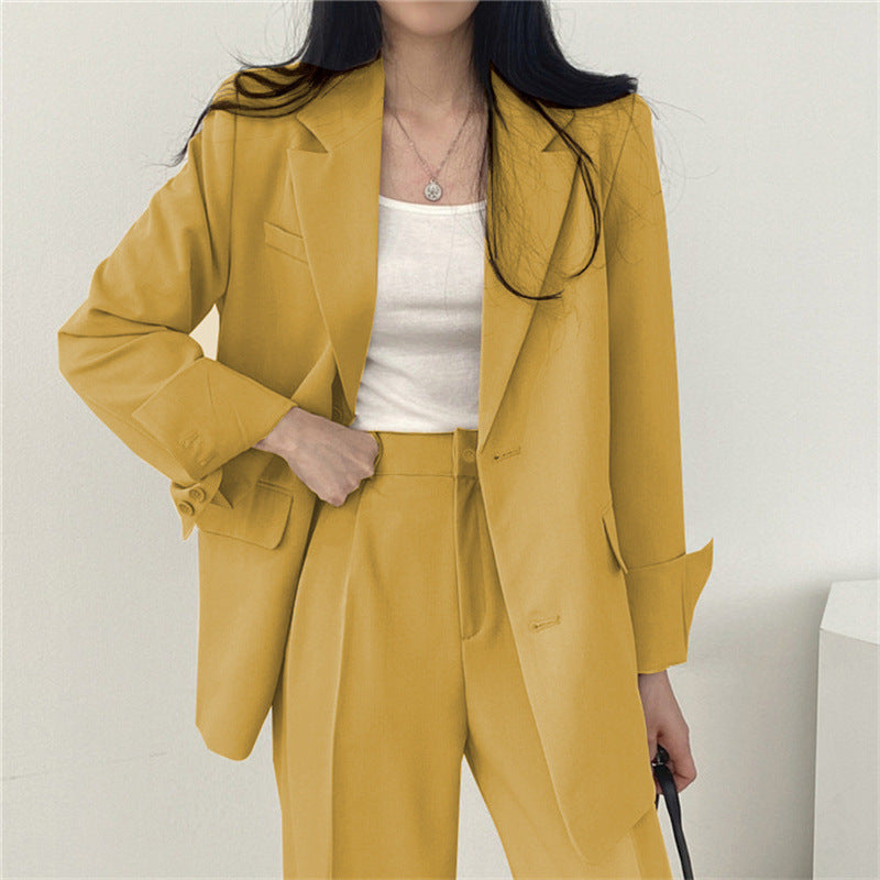 Formal women's trouser set featuring a sleek tailored blazer and relaxed fit pants for elegance.