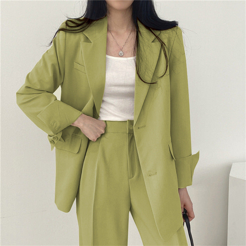 Women's smart casual elegance: tailored blazer and relaxed fit trousers, a stylish two-piece outfit.
