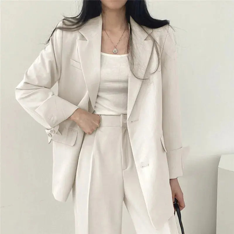 Office chic women's outfit: elegant tailored blazer and comfortable relaxed fit trousers.