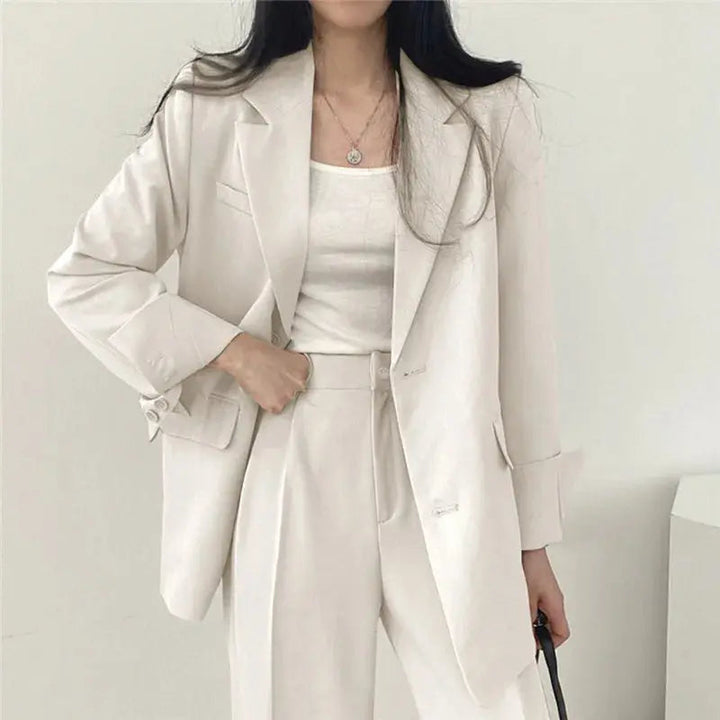 Office chic women's outfit: elegant tailored blazer and comfortable relaxed fit trousers.