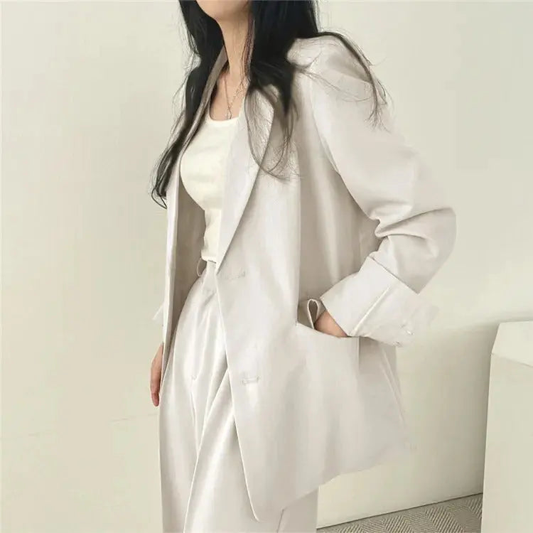 Women's versatile two-piece set, combining a sleek tailored blazer with relaxed fit professional trousers.